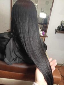 Zbliżenie na idealnie gładkie i lśniące długie włosy po zabiegu głębokiej rekonstrukcji Framesi Morphosis Restructure.